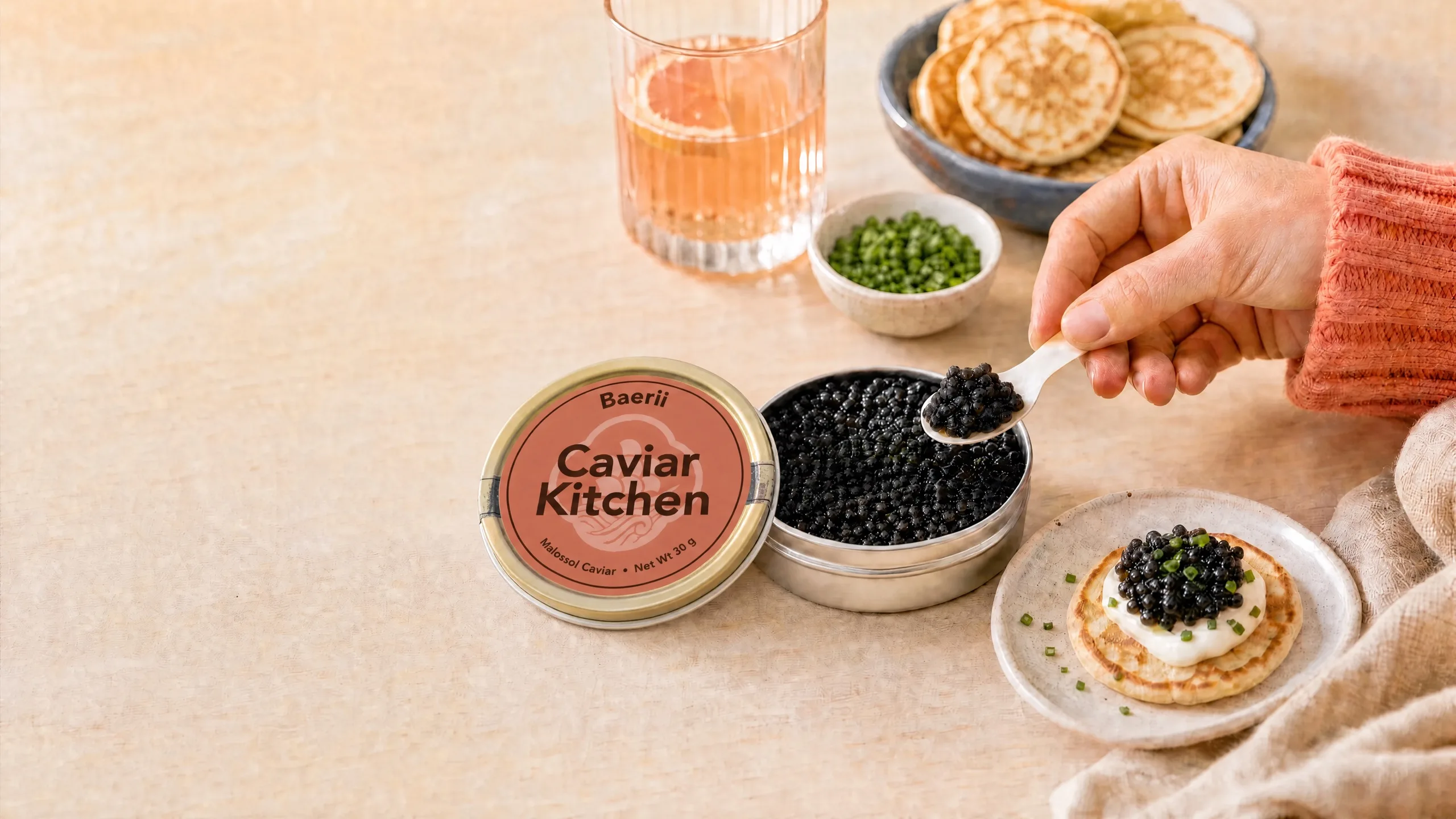 A tin of caviar served with a mother-of-pearl spoon.
